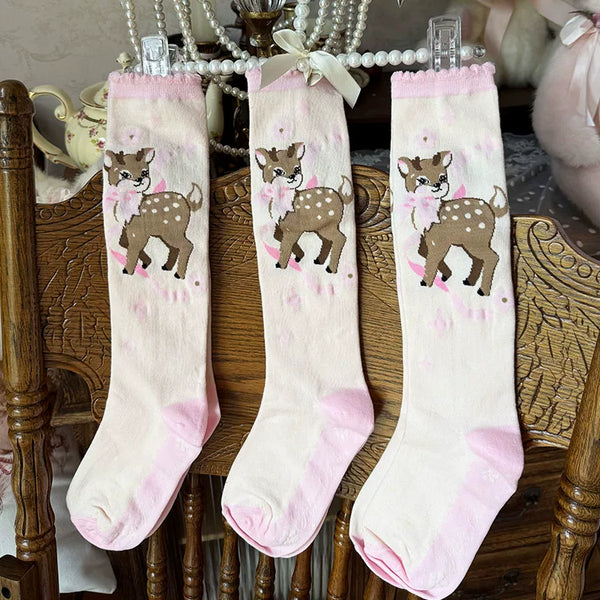 Cream mid-calf lolita socks with brown deer print, pink bow, scalloped pink cuff, and ribbed knit texture.