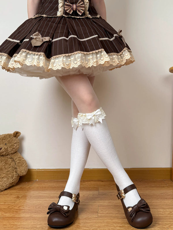 Brown and white lace-cuff socks styled with bow details beneath a Lolita skirt.