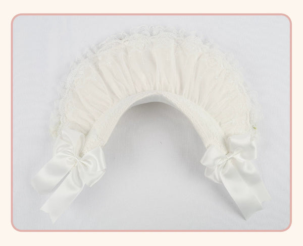 White lace-trimmed flat hat with a pleated crown and long side bows, shown flat.