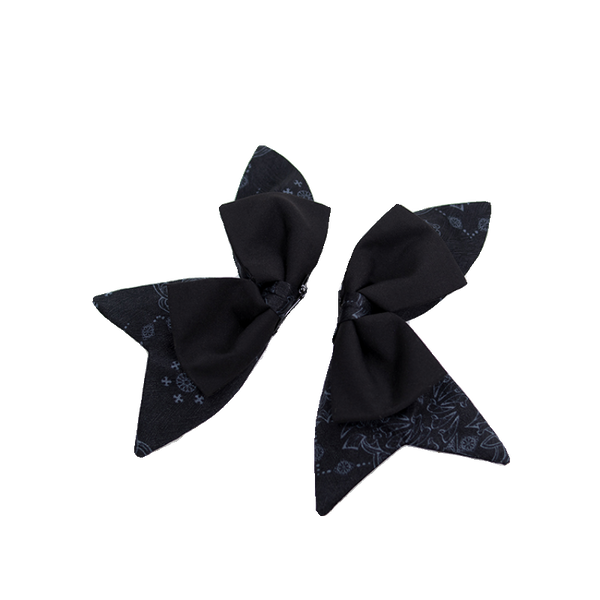 Black printed bow hair clips with layered tails shown as a pair.