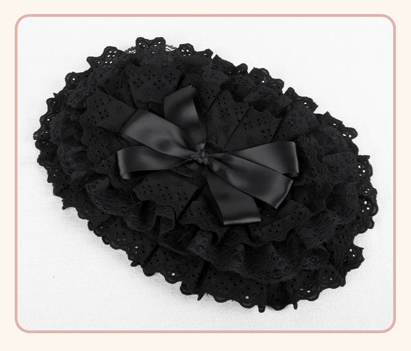 Black BNT flat hat with layered lace trim and ribbon bow displayed on a white background.
