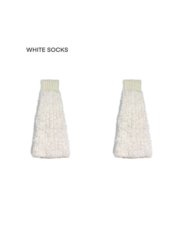 Model wearing off-white and gray slouchy knitted leg warmers with plush sections over pointed shoes.