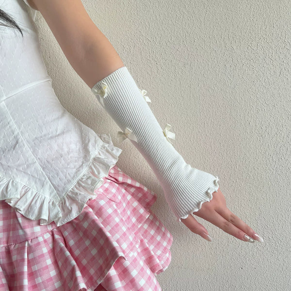 White fingerless ribbed arm warmers with small bows and ruffled edges