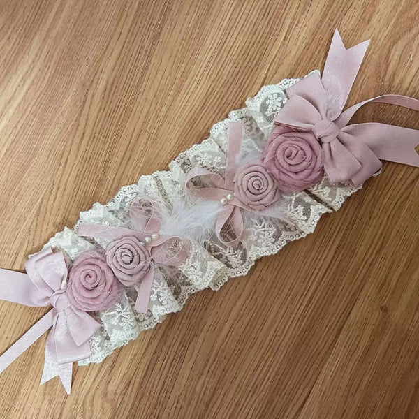 Satin-pink lace accessory with ribbon bows and hand-rolled roses