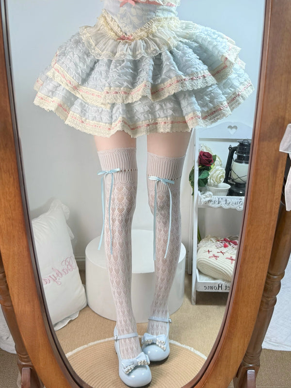White over-the-knee socks with pale blue bows styled with a ruffled Lolita skirt