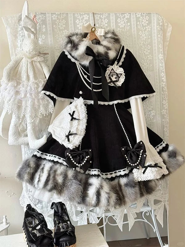 Black-and-white Lolita dress set with a lace cape, fluffy trim and white layered sleeves displayed on a hanger.
