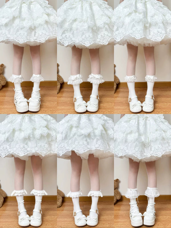 White Lolita sock collection with lace, bows and layered trims, shown in multiple variants.