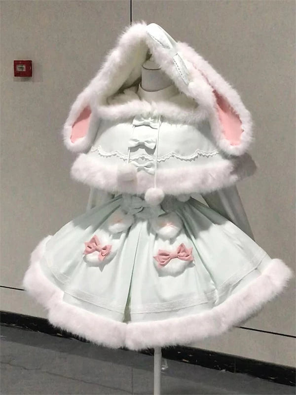 Green rabbit-ear cape and dress set with white trim and pink bows on a mannequin