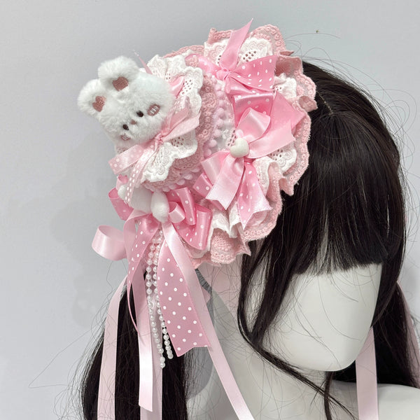 Pink lace rabbit-themed headwear with layered bows and pearl strands on a model head.
