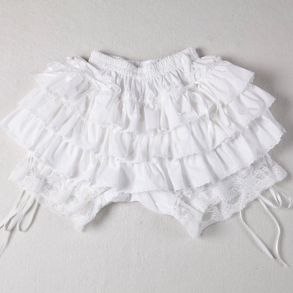 Milky-white layered ruffle skirt with pumpkin shorts shown with a cream top and lace details.