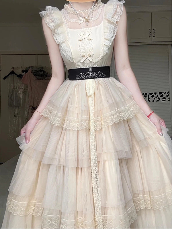 Ivory tiered OP dress with ruffled cap sleeves, scalloped lace edging and a waist belt.