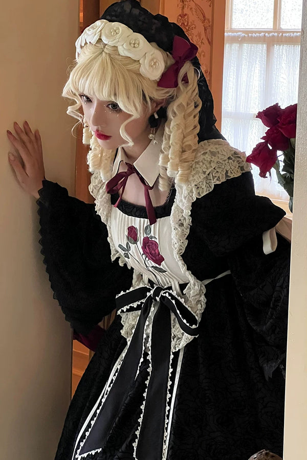 Black rose-embroidered Gothic Lolita OP dress with white lace trim and a large back bow on a mannequin