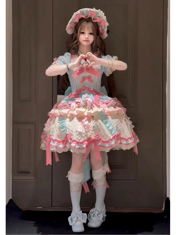 Mint, pink, and cream Lolita dress with layered ruffles, bows, a train, and matching hat.