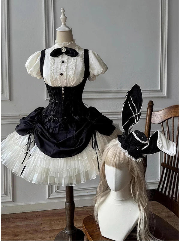 Black-and-white JSK set displayed on a mannequin with a white blouse, black bow tie and hat.