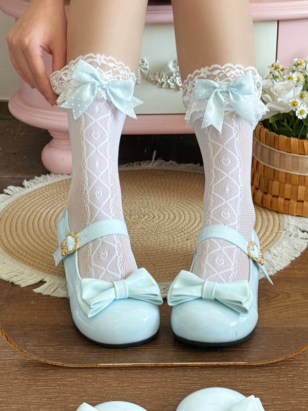 White patterned mid-calf socks with lace cuffs and pink bows styled with pale pink Mary Janes
