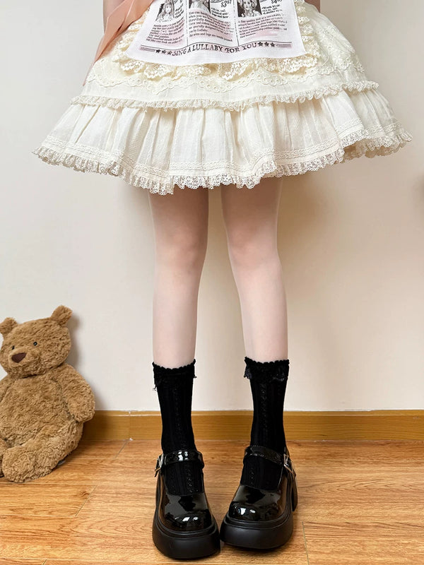 Model wearing white ribbed mid-calf socks with scalloped lace cuffs and black Mary Jane shoes.
