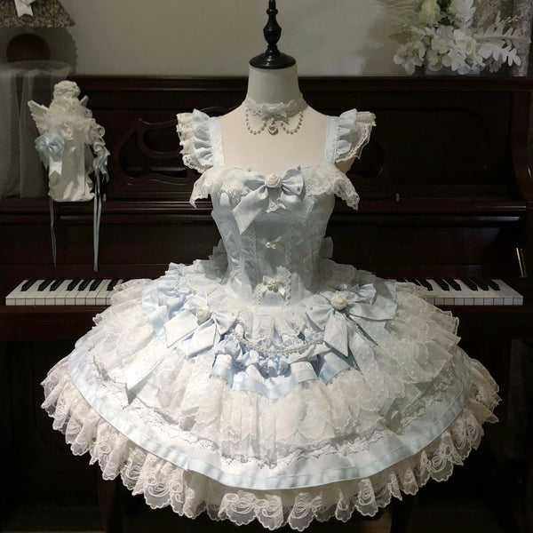 Soft pink balletcore Lolita JSK on mannequin, featuring corset-style front lacing, satin bow accents, and fabric rose embellishments