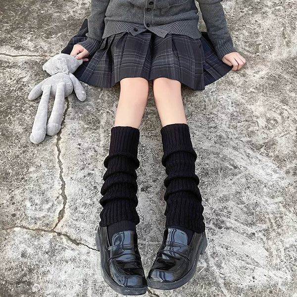 Milky white knit sock covers with pink heart buckles and long elastic ties worn with platform shoes.