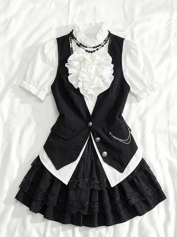 White ruffled blouse, black vest and layered black short skirt