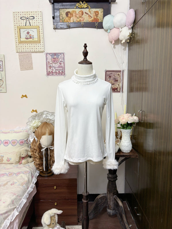 White high-neck Lolita base-layer top with lace collar and fuzzy cuffs displayed on a mannequin.