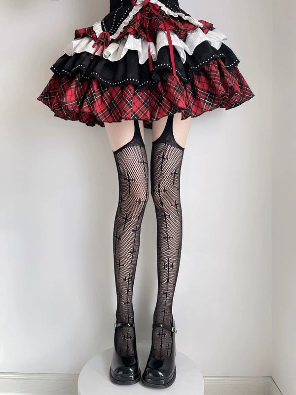 Black fishnet thigh-high stockings with repeated cross motifs styled with a red-and-black skirt and platform shoes.