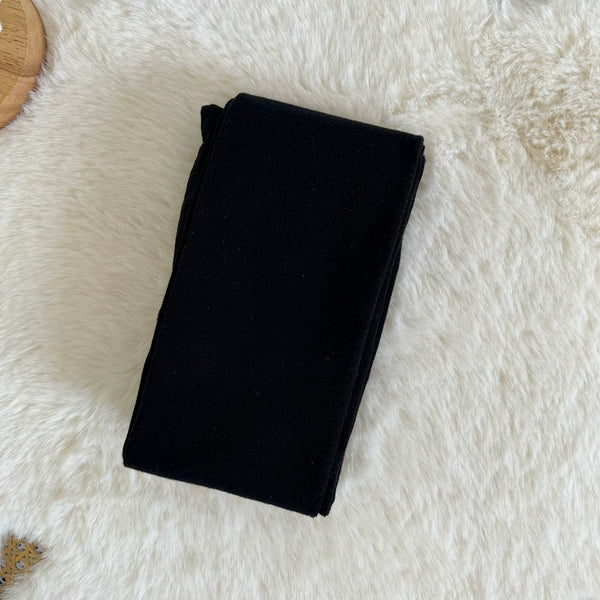 Gray ribbed fleece-lined tights shown beneath a black skirt and sweater.