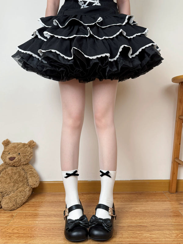 Milk-white socks with black bows styled with a black ruffled skirt and black shoes.