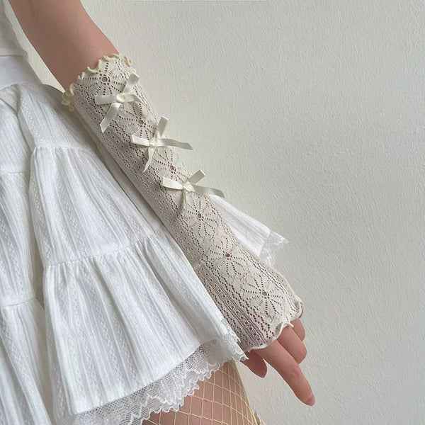 White lace arm sleeve with small ribbon bows and ruffled edging.