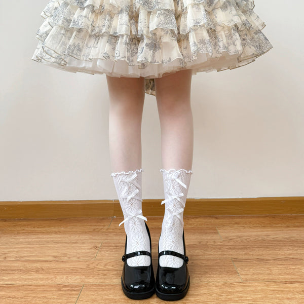 White openwork lace socks with ribbon lacing and decorative trim worn with a Lolita outfit