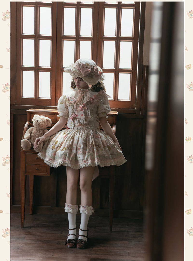 Antique-style printed doll dresses with lace, bows and coordinated brooch accessories.