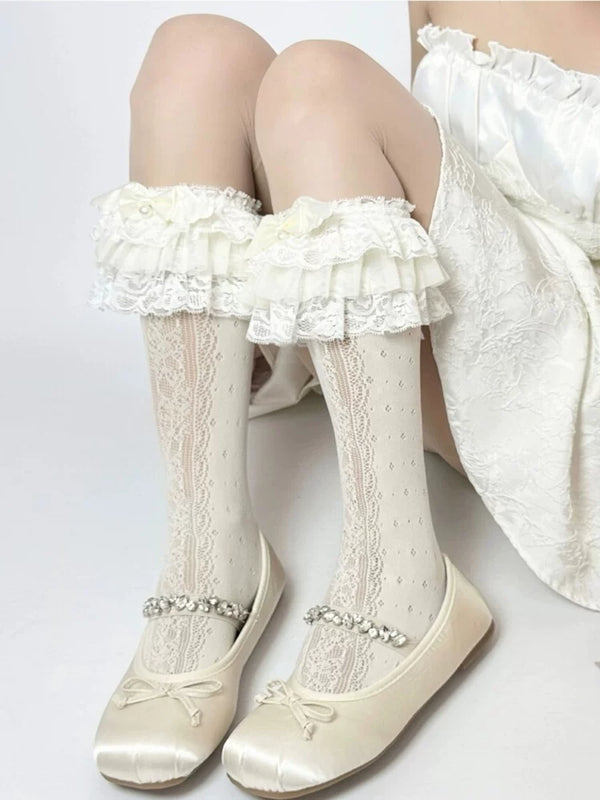 White lace cuff socks with bows styled with pale Lolita clothing and Mary Jane shoes.
