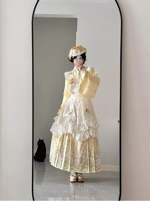 Yellow Hanfu-inspired set with a cross-collar pipa-sleeve top, floral mamian skirt, ruffled overskirt and shawl.