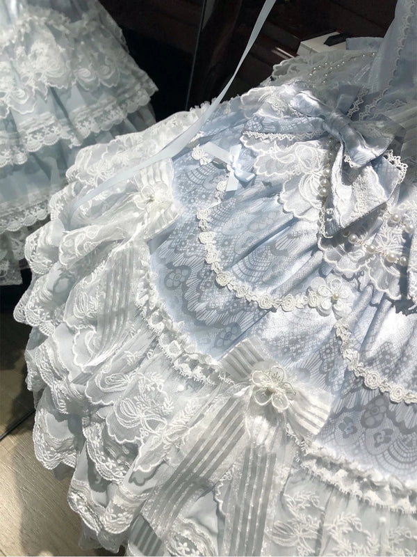Creamy blue JSK dress with layered lace and bows on a mannequin