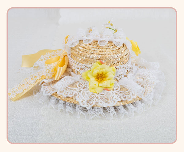 Straw flat hat hair clip with white lace trim, yellow ribbon and a yellow flower.