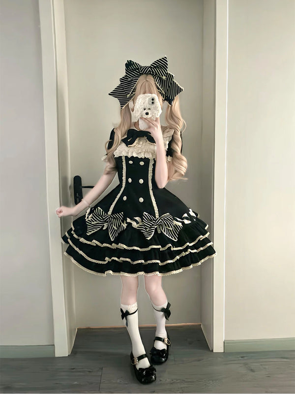 Black tiered Lolita dress with striped bows, white ruffle trim and bow headwear.