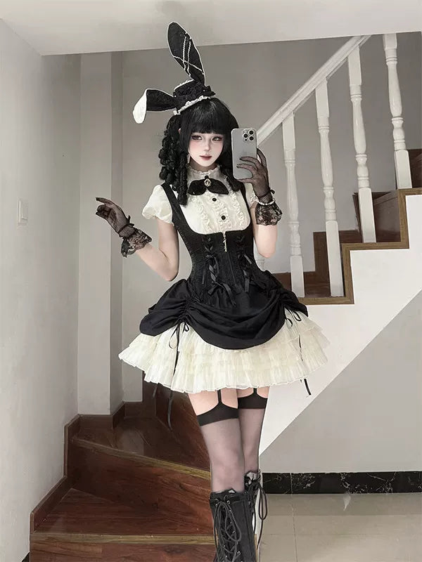 Black Gothic Lolita JSK with white ruffles and rabbit-ear hat, worn by a model.