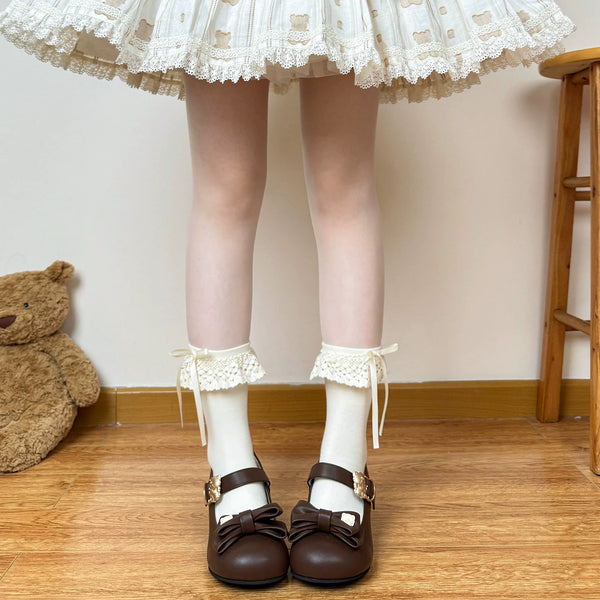 Chubby Bear Tales beige and white lace socks with bows styled on a model.