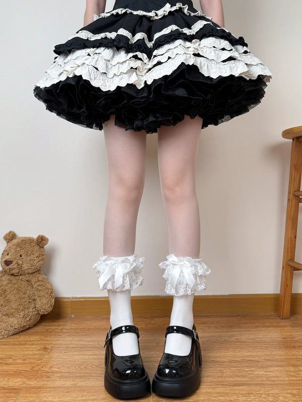Black-and-white lace socks worn with layered Lolita skirts and Mary Jane shoes.
