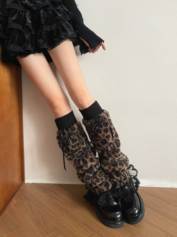 Leopard-print long sock covers with black ribbed cuffs, ribbon ties and lace edging styled with platform shoes.