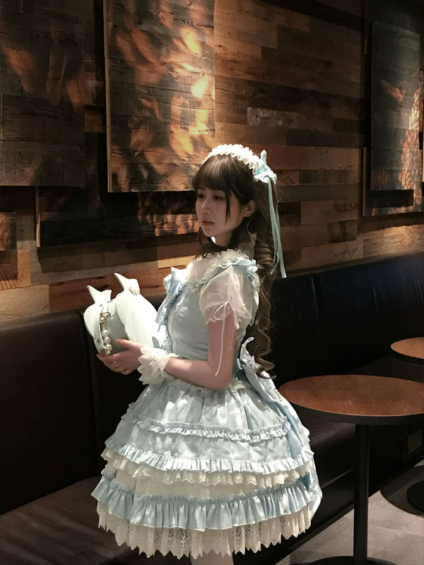 Model wearing full Shengqing Ice Blue Overture JSK set in pale blue with coordinating accessories
