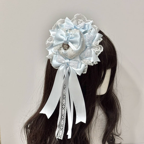 Light blue lace-and-bow mini top hat shown on a mannequin.