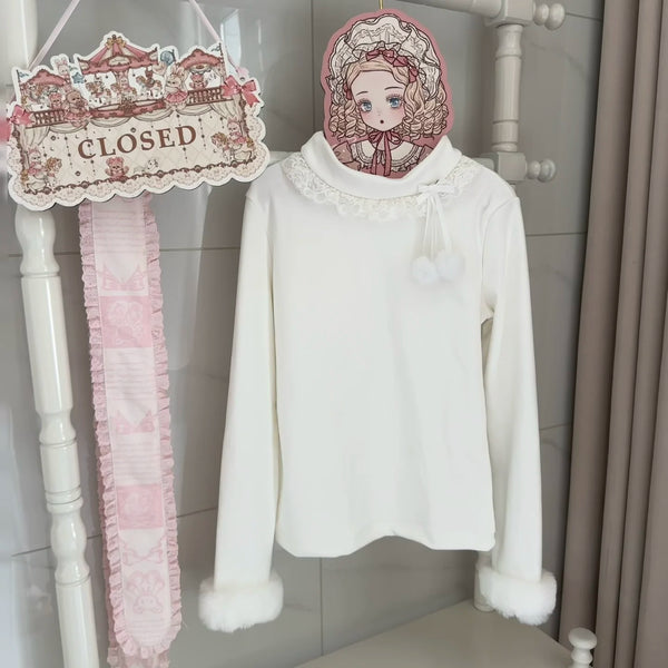 White long-sleeve inner top with lace collar and fuzzy cuffs displayed against a decorative backdrop