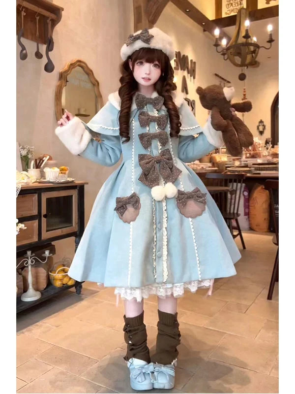 Model wearing a pale blue Lolita coat and cape with layered bows