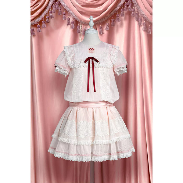 Pink-and-white low-waist one-piece dress with strawberry-themed panels and layered lace tiers.