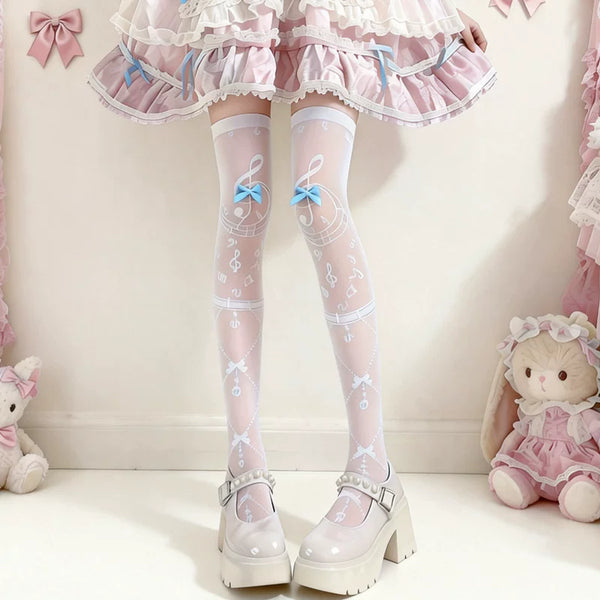 White thigh-high socks with musical-note motifs and pastel bows styled with a pink Lolita skirt.
