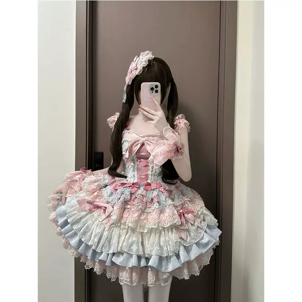 Blue-pink ruffled JSK with layered skirt and bows shown in a mirror outfit photograph