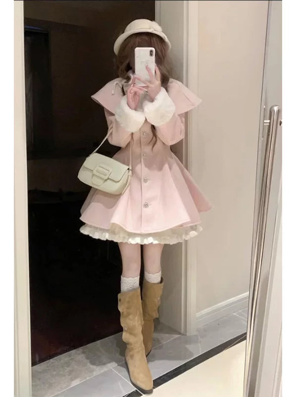 Pink OP dress with cape-like shoulders, fluffy cuffs and a white frill hem shown in a mirror selfie.