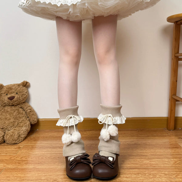 Khaki slouch leg warmers with lace cuffs and pom-pom ties.