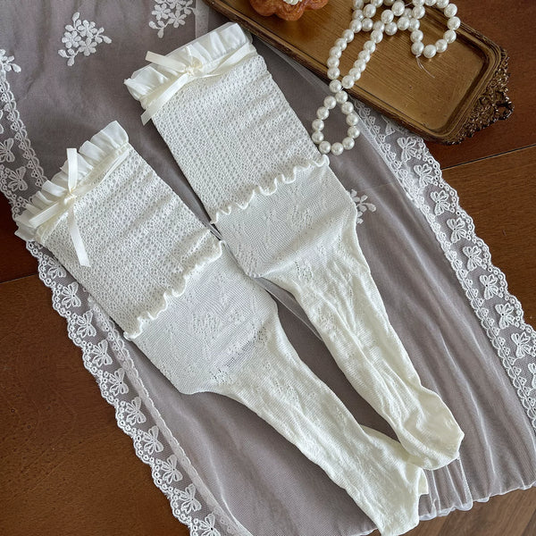 Cream and white layered lace hosiery with bows and fishnet panels styled on a model.
