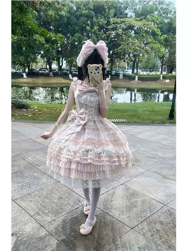 Pink lace JSK with layered ruffles, waist bow, and matching hair accessory